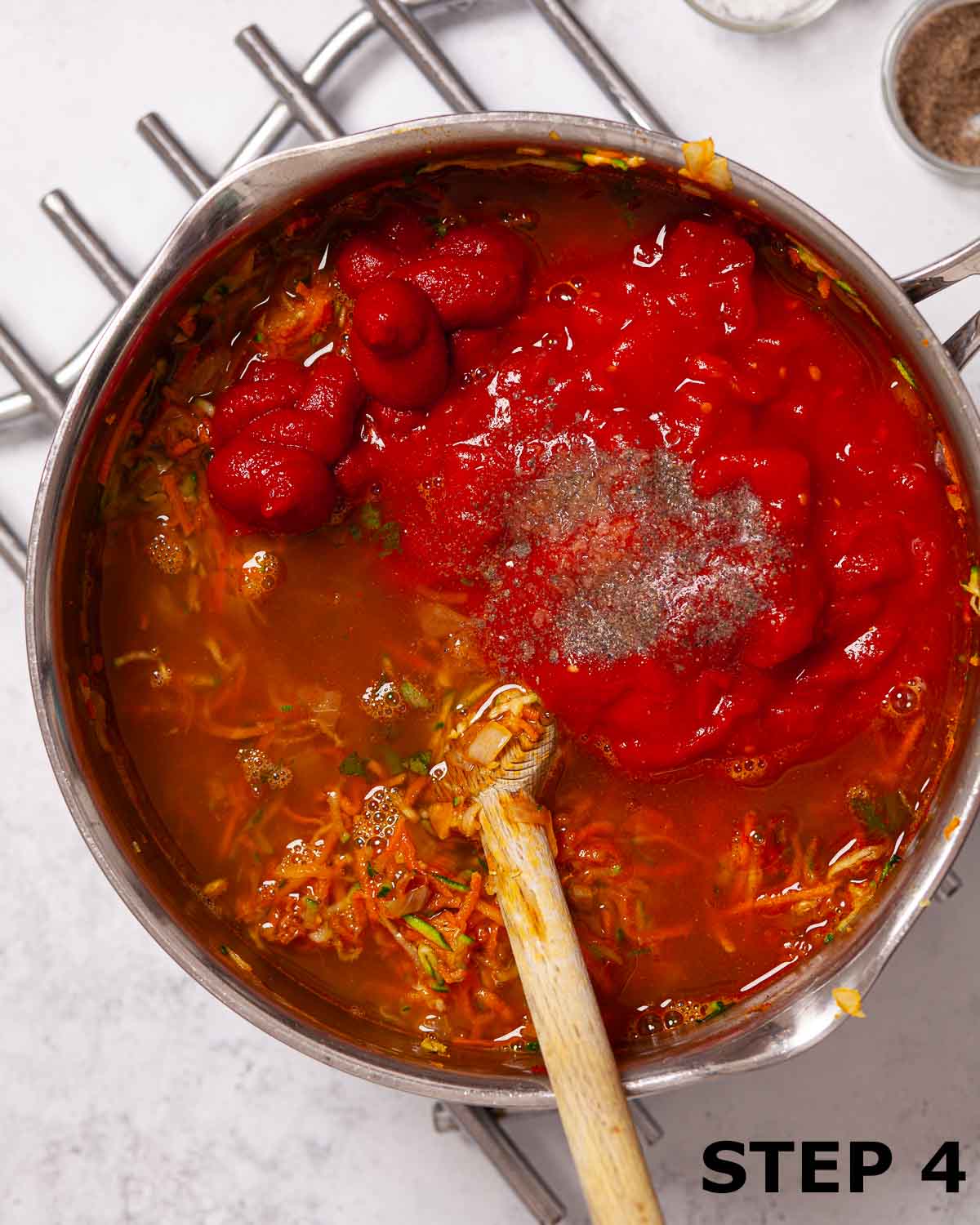Tinned tomatoes, tomato puree and stock added to other ingredients for homemade soup.