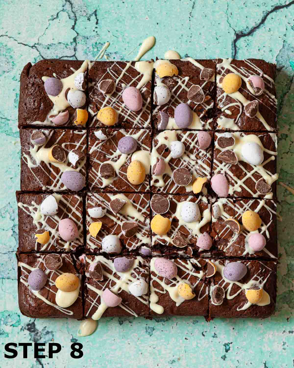 Mini egg brownies topped with white chocolate and chopped chocolate Easter eggs cut into squares.