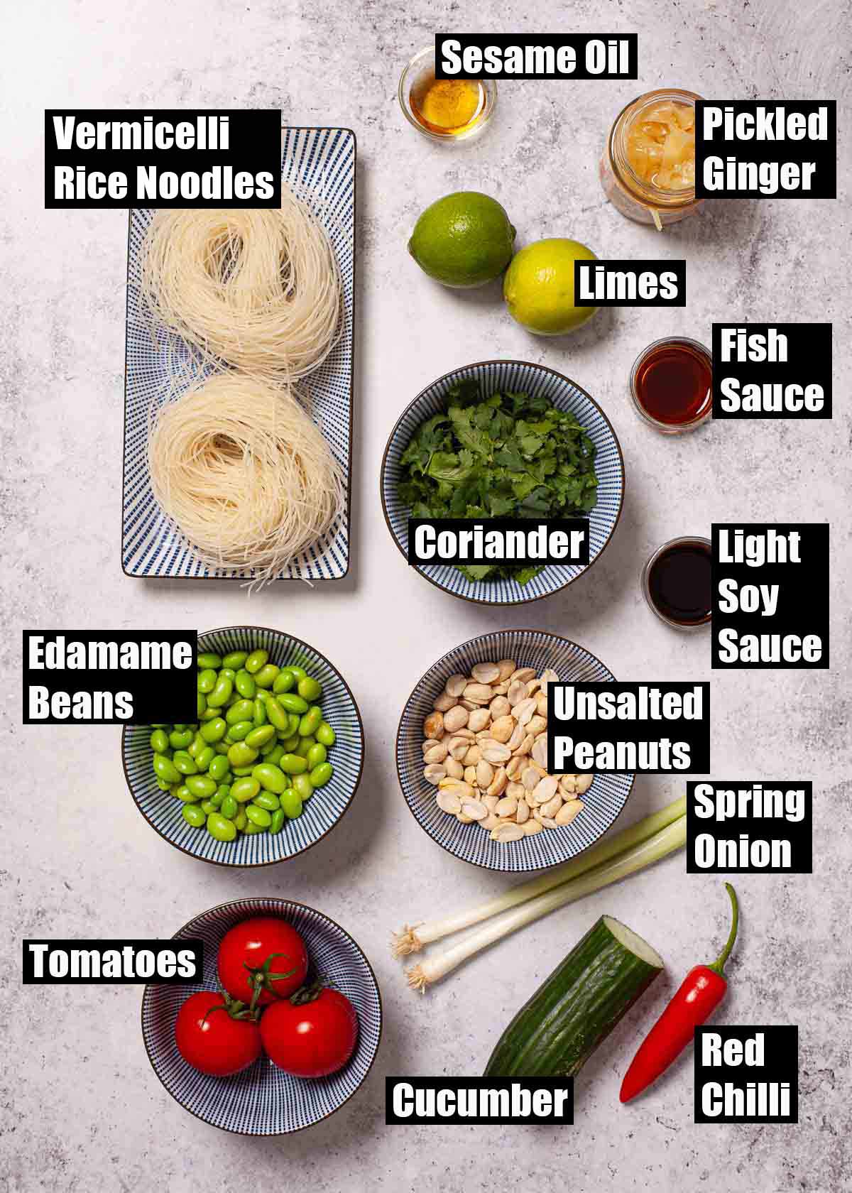 Labelled ingredients for a cucumber and tomato noodle salad with pickled ginger dressing.