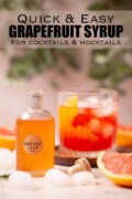 A bottle of grapefruit simple syrup in front of a grapefruit negroni cocktail with text overlay.