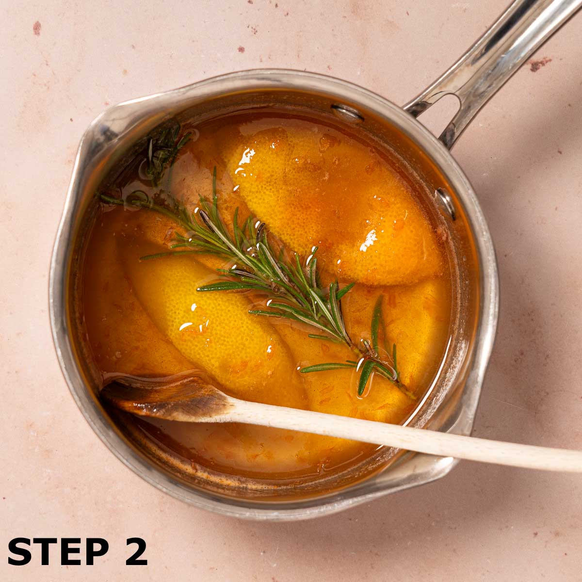 Rosemary and grapefruit zest infusing in a pan of grapefruit simple syrup.
