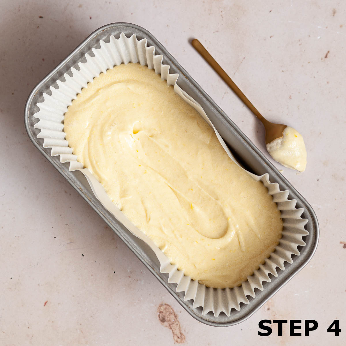 Cake batter in a loaf tin ready to bake.
