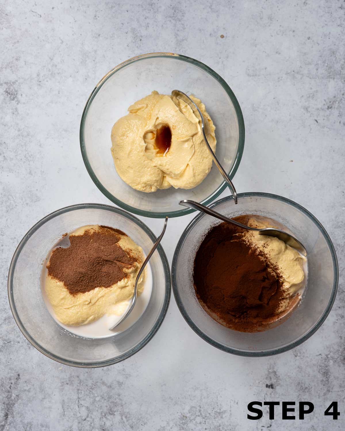 Three bowls of cake batter with different flavours added to each (vanilla, malted milk and cocoa).