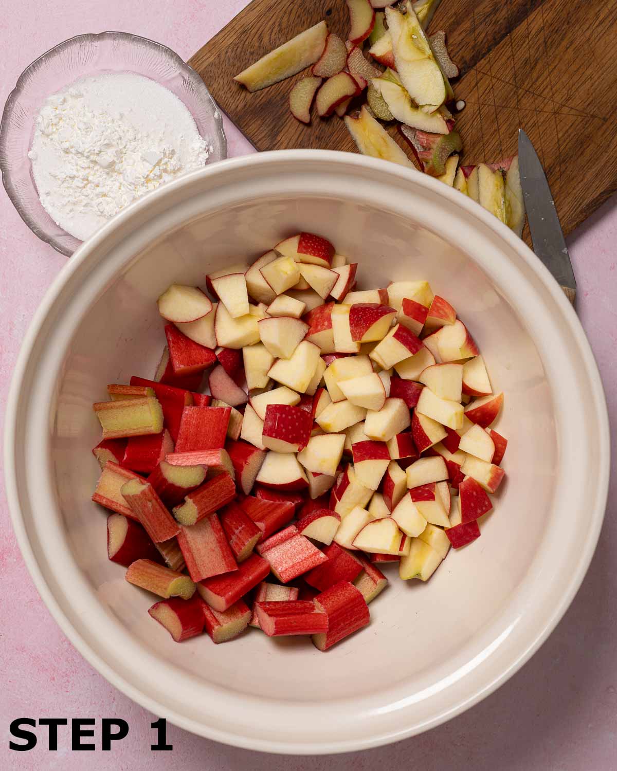 Chopped apple and rhubarb in a large mixing bowl.
