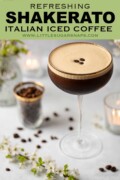 Labelled caffe shakerato in a cocktail glass with a gold rim and garnished with coffee beans.