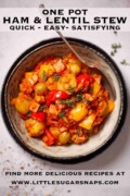 A bowl of lentil and potato stew with ham on a grey background with text overlay.