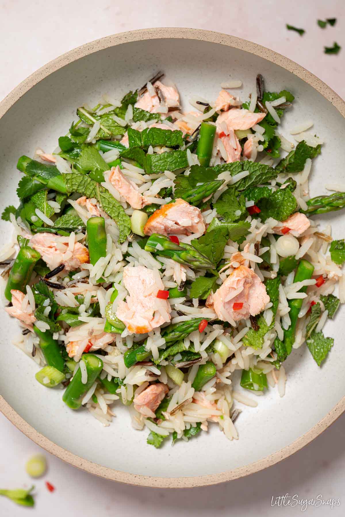 Salmon rice bowl with wild rice, asparagus, mint, coriander and chilli.