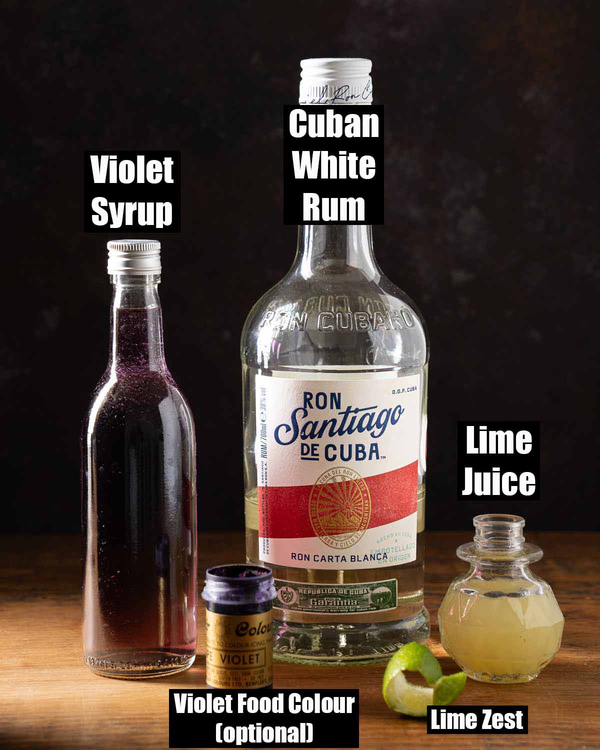 Labelled ingredietns for a violet syrup cocktail.