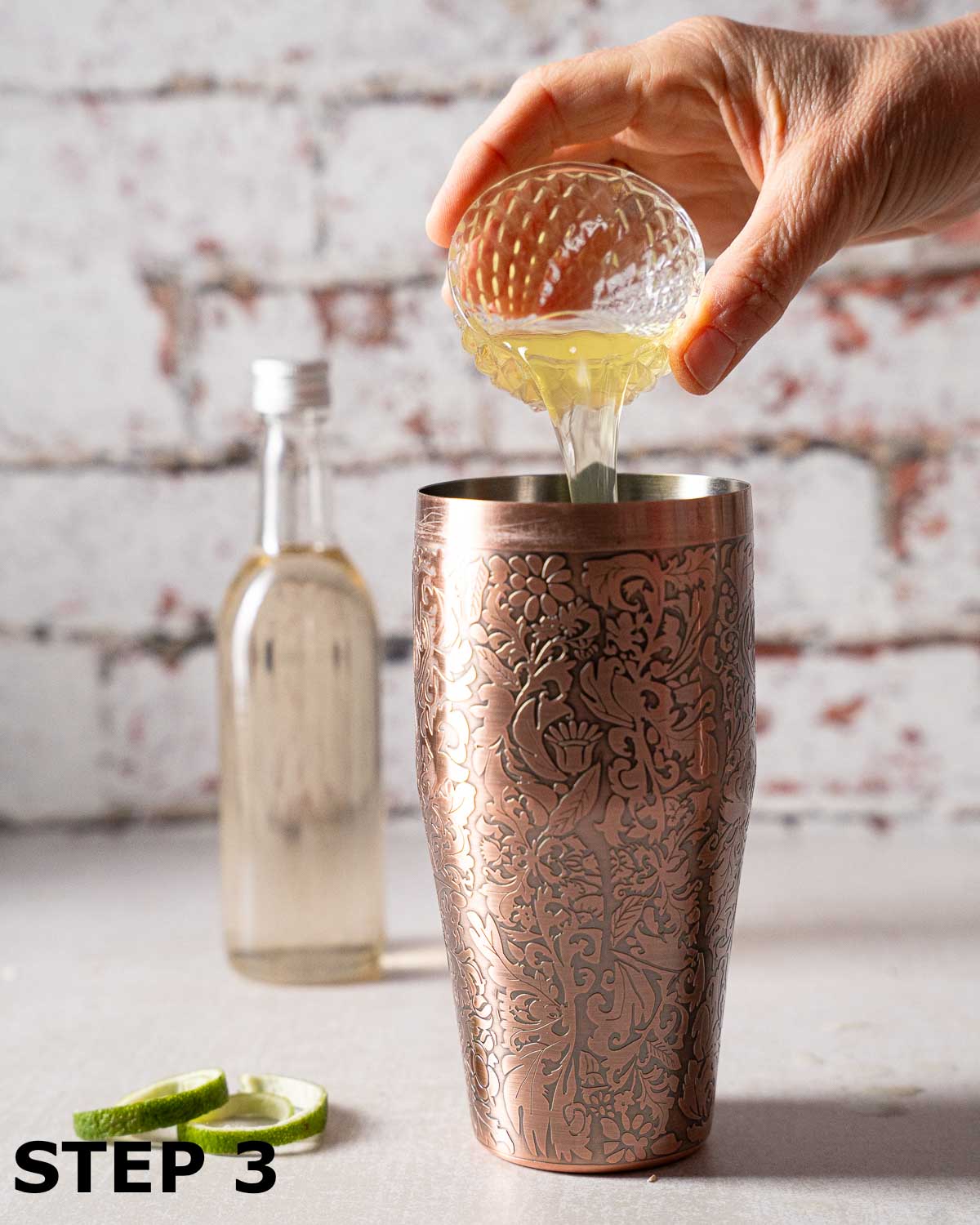 Egg white being added to a cocktail shaker.