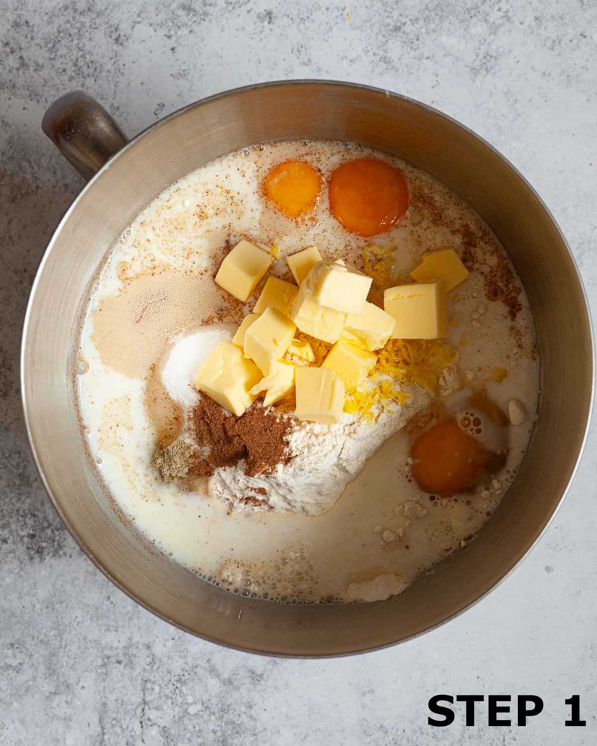 Ingredients for enriched dough for sweet lemon rolls in a mixing bowl.