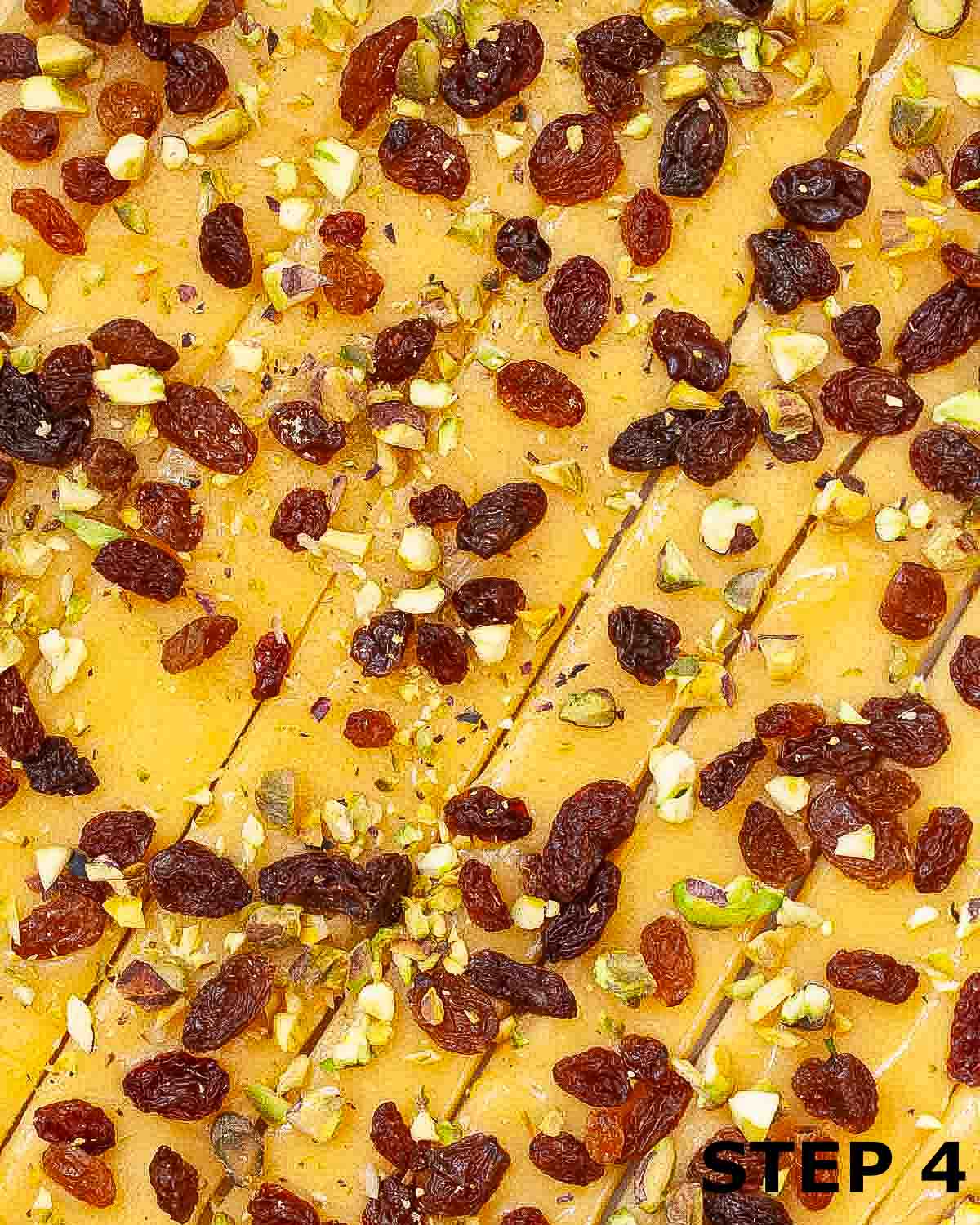 Dough that has been cut into strips and topped with lemon curd, pistachios and raisins.