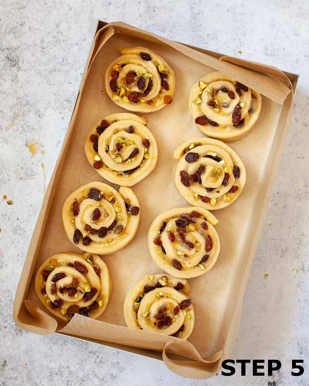 Lemon curd rolls in a baking tin prior to baking.