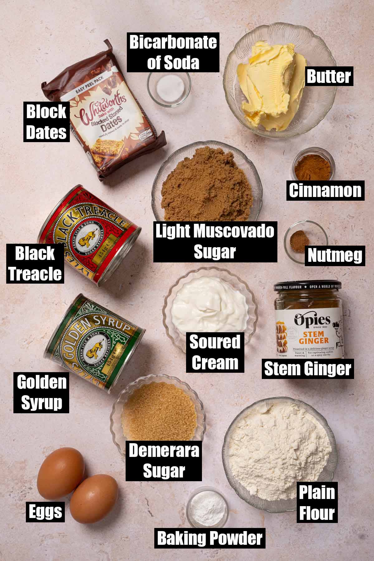 Labelled ingredients for a sticky date cake with dates and stem ginger and a Demerara topping.