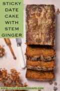 Labelled sticky date loaf cake with crunchy Demerara sugar topping with three slices cut from it.
