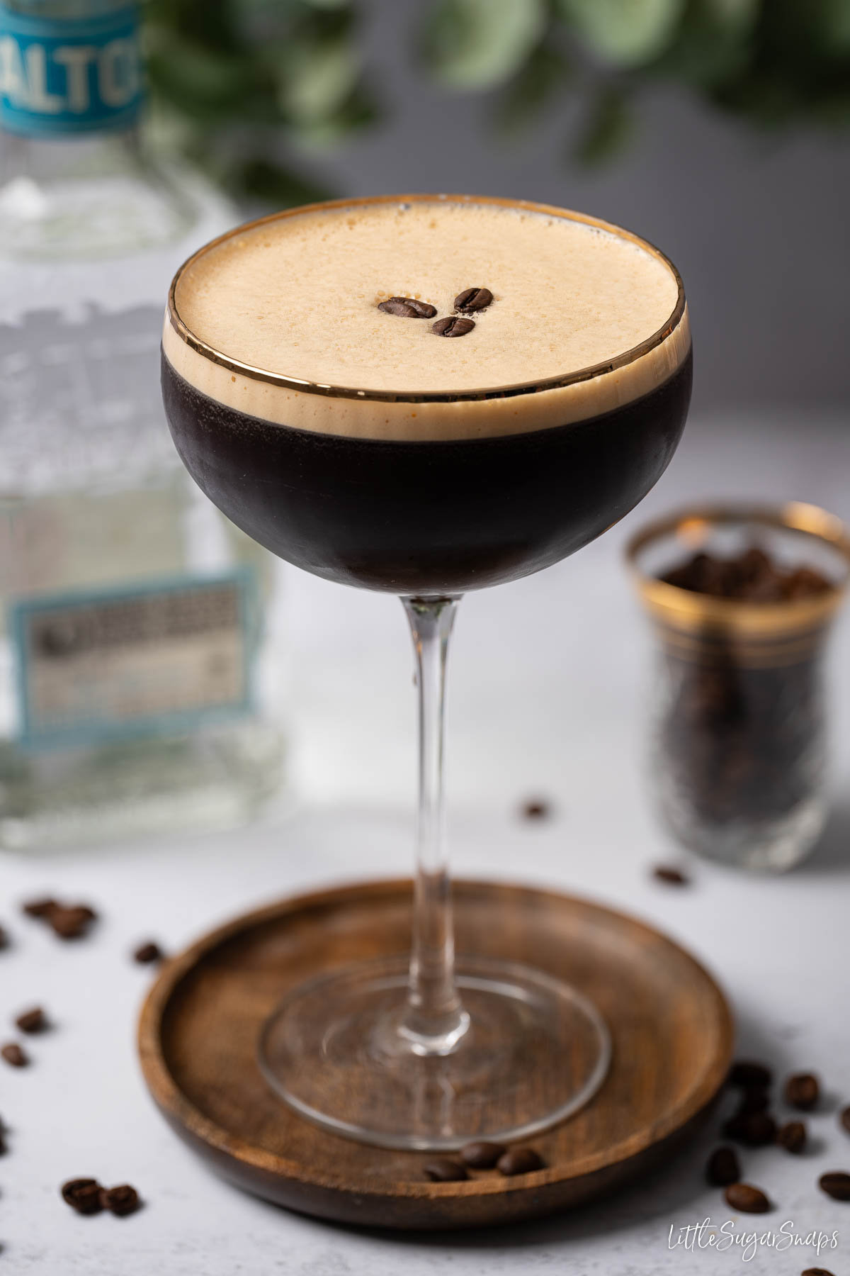 A Mexican espresso martini made with tequila with crema top and coffee bean garnish.