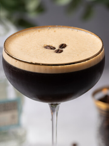 A tequila espresso martini with crema top and coffee bean garnish.