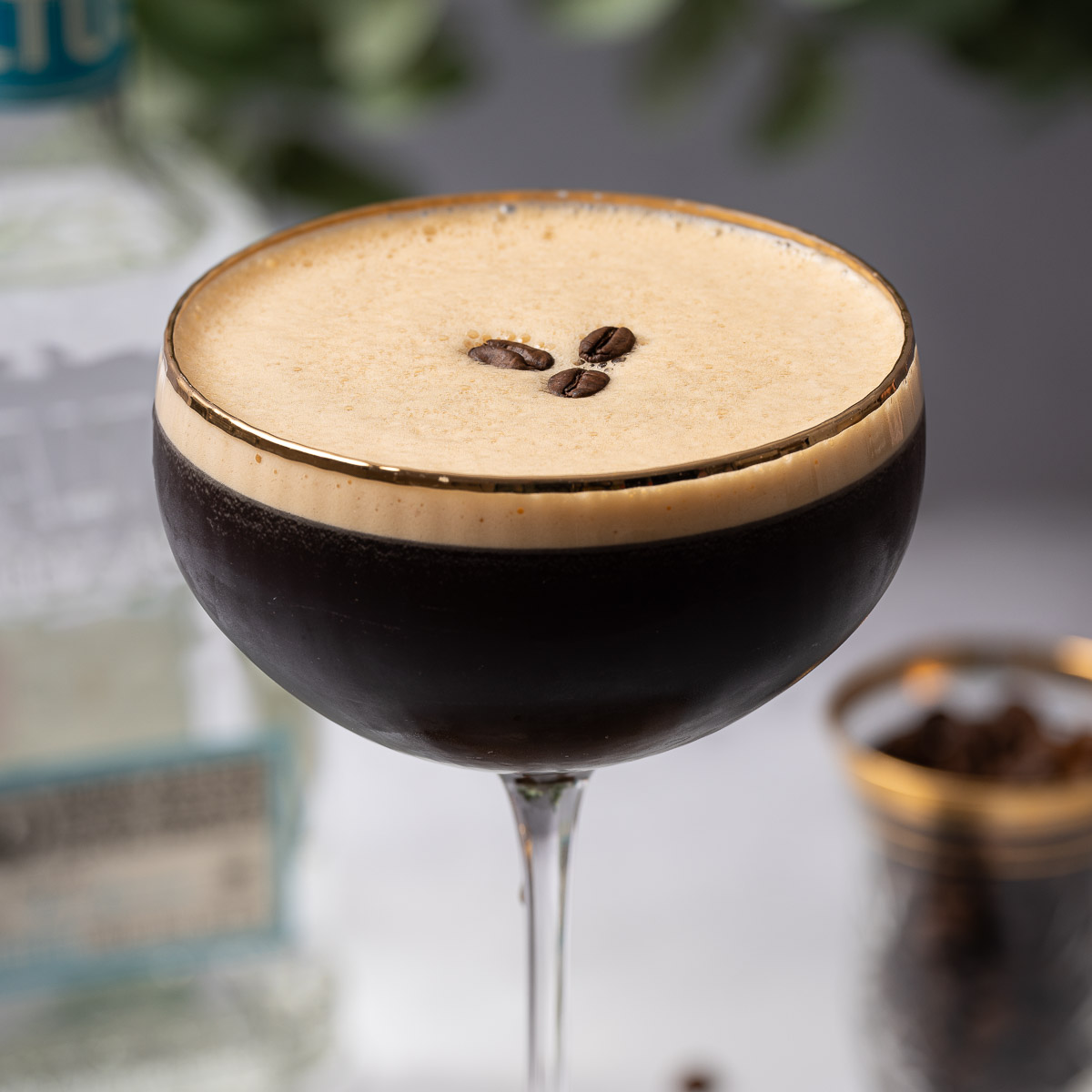 A tequila espresso martini with crema top and coffee bean garnish.
