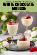 Three glasses of white chocolate mousse with chocolate and raspberry garnish with text overlay.