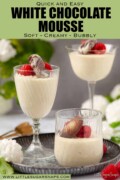 Three glasses of white chocolate mousse with chocolate and raspberry garnish with text overlay.