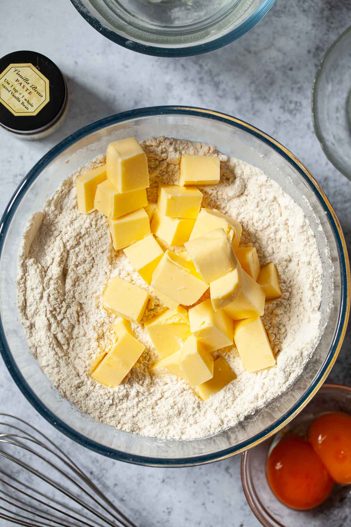 Cubed butter in a bowl with flour.