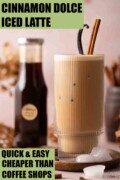 Labelled iced cinnamon latte with cinnamon stick and vanilla pod garnish.