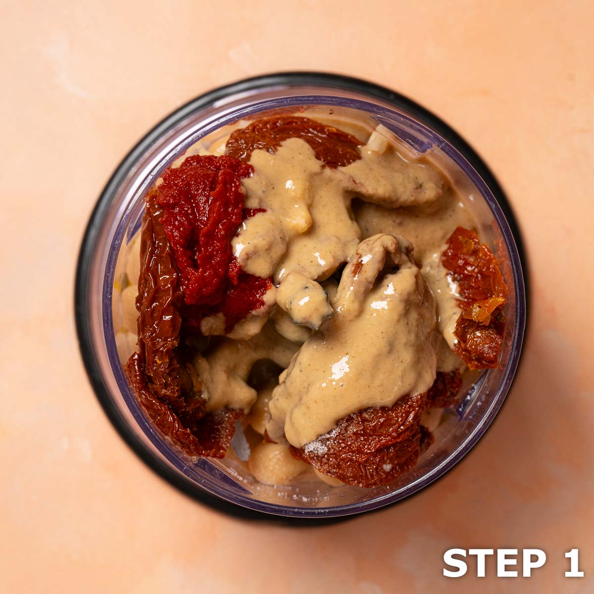 Ingredients for butter bean hummus with sundried tomato in a food processor bowl.