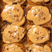 Coffee buns topped with coffee glaze and chopped pecan nuts.