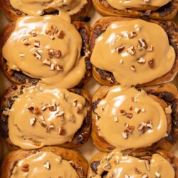 Coffee buns topped with coffee glaze and chopped pecan nuts.
