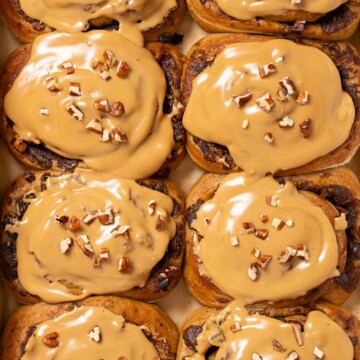 Coffee buns topped with coffee glaze and chopped pecan nuts.