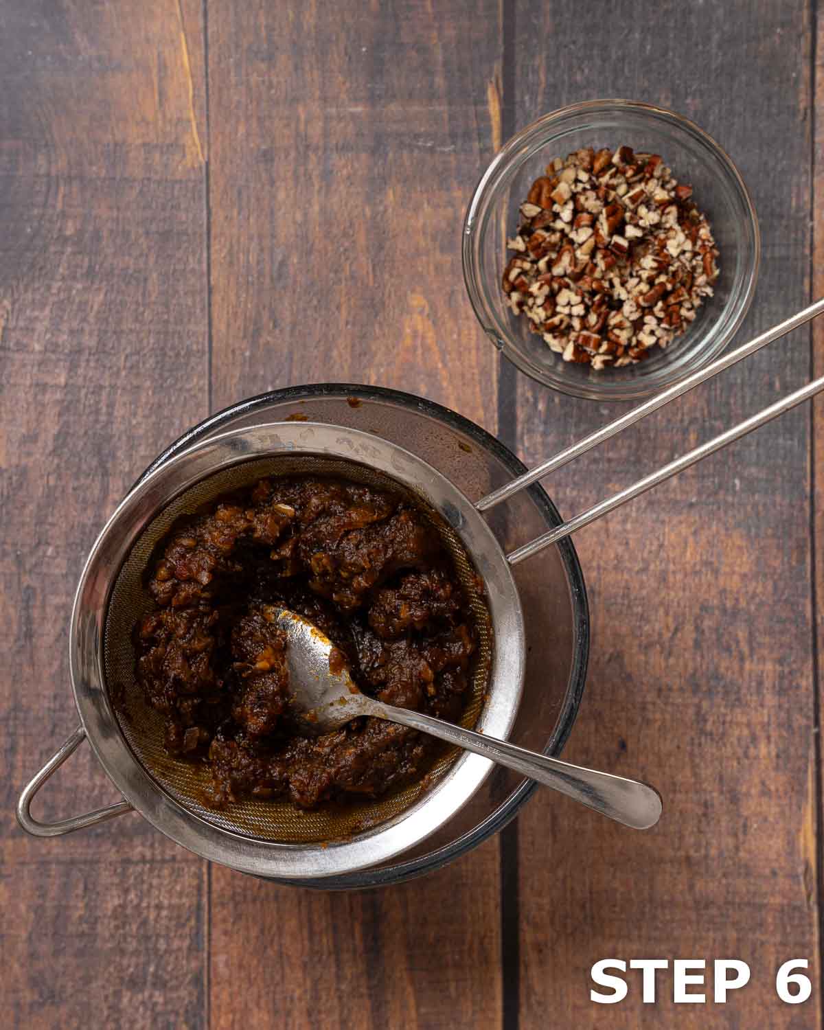 Soaked block dates draining in a sieve and a bowl of chopped pecan nuts.