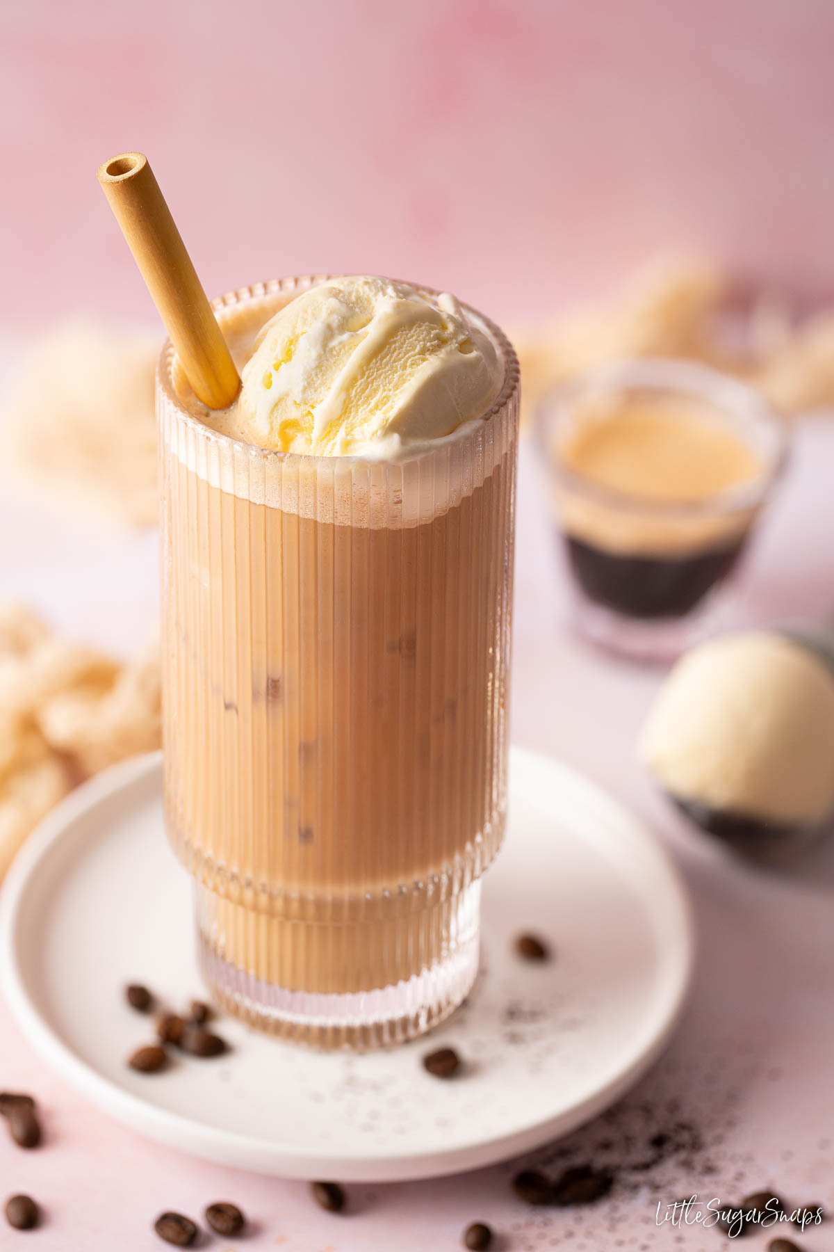 A glass of iced latte with ice cream on the top.
