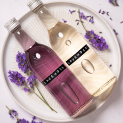 Bottles of labelled lavender simple syrup, one is clear, the other is purple.