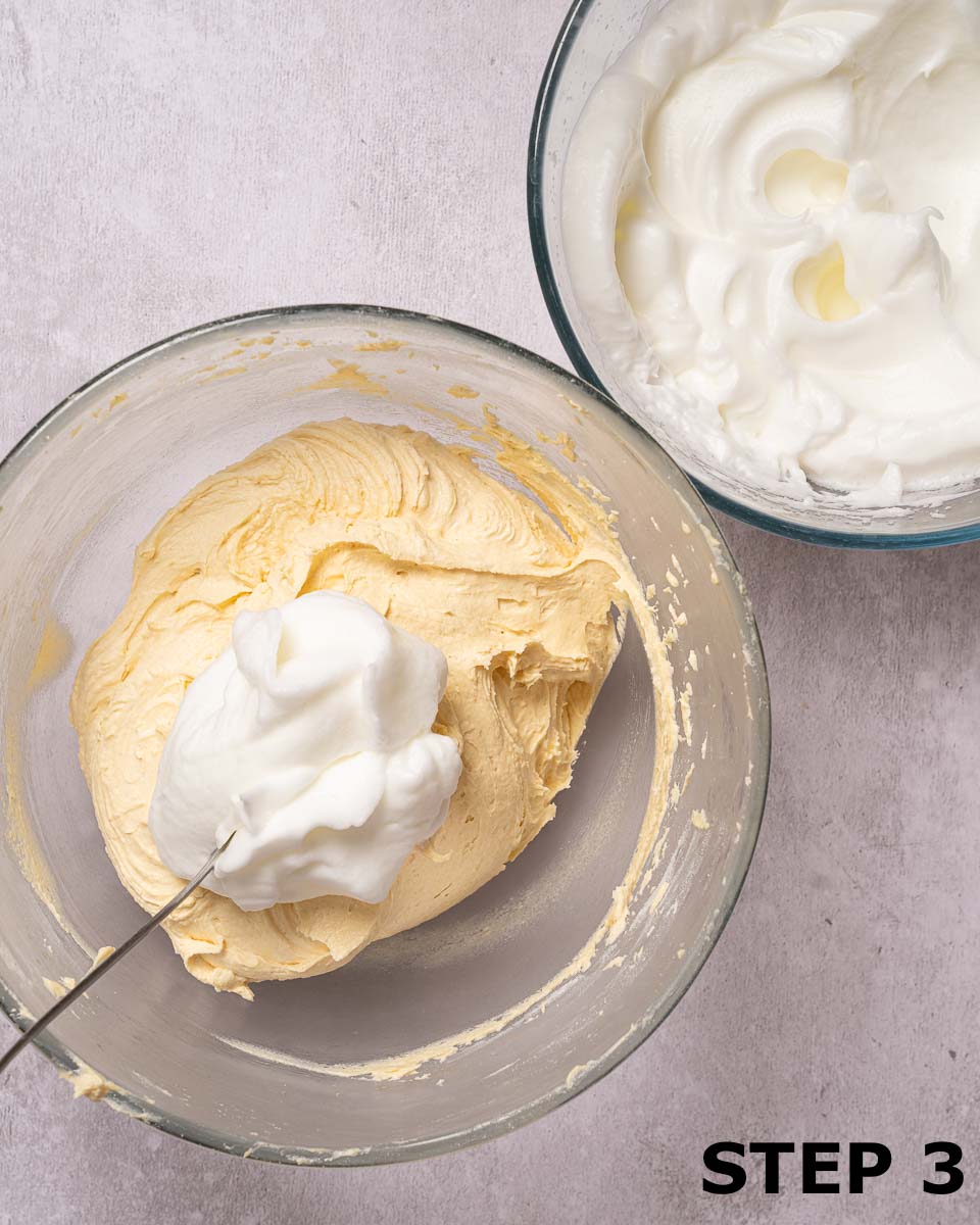 Whisked egg white in a bowl of cake batter made using the separated egg technique.