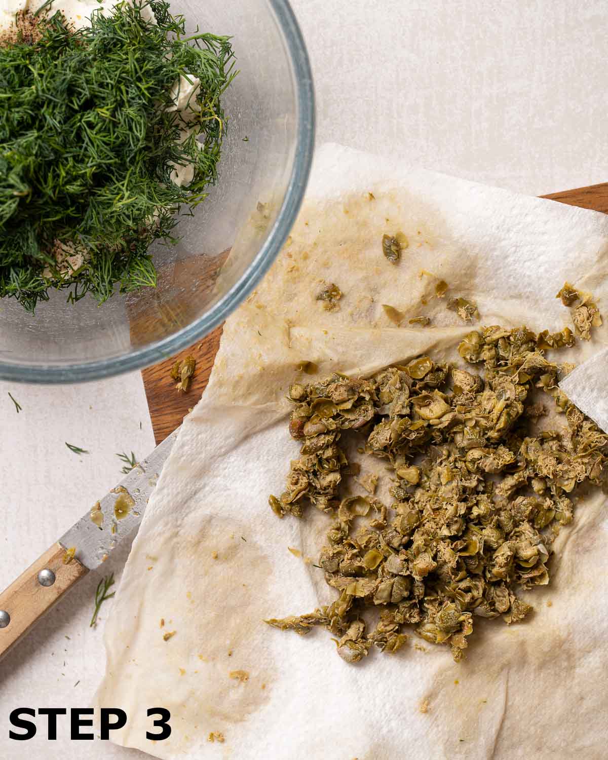 Chopped capers draining on kitchen towel.