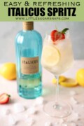 Labelled Italicus spritz with lemon and strawberry garnish with a bottle of Italicus liqueur.