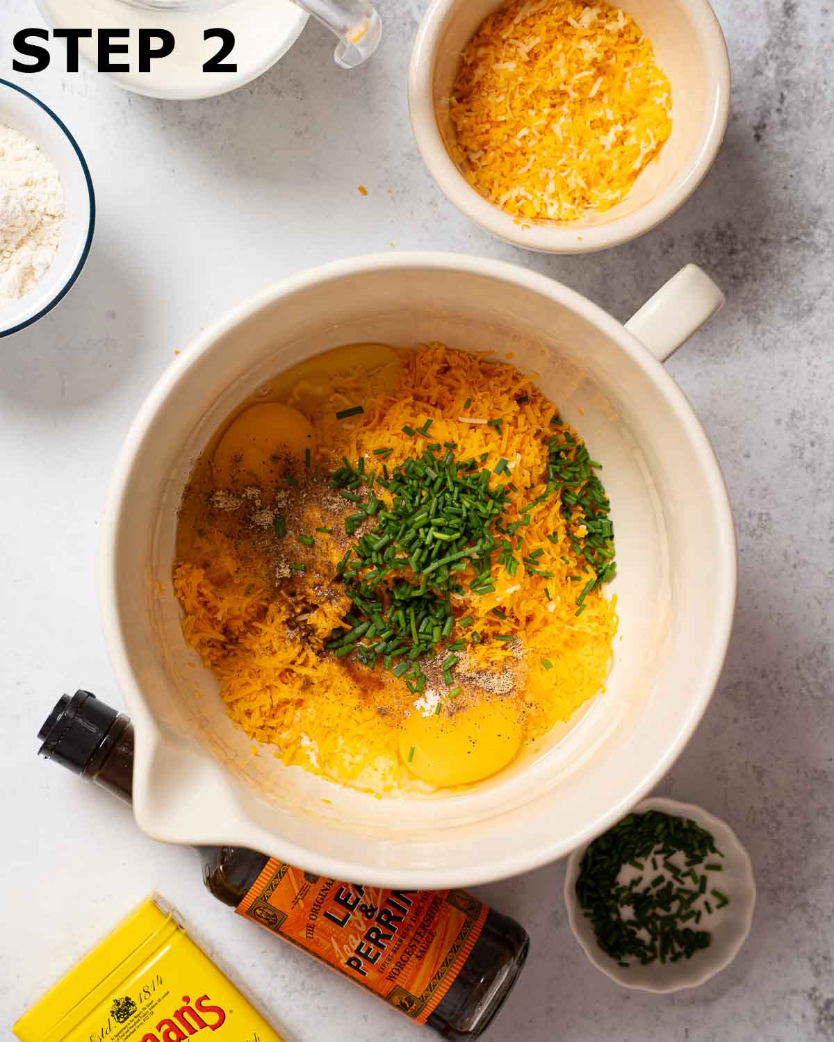 Ingredients for savoury cheese custard in a mixing jug.